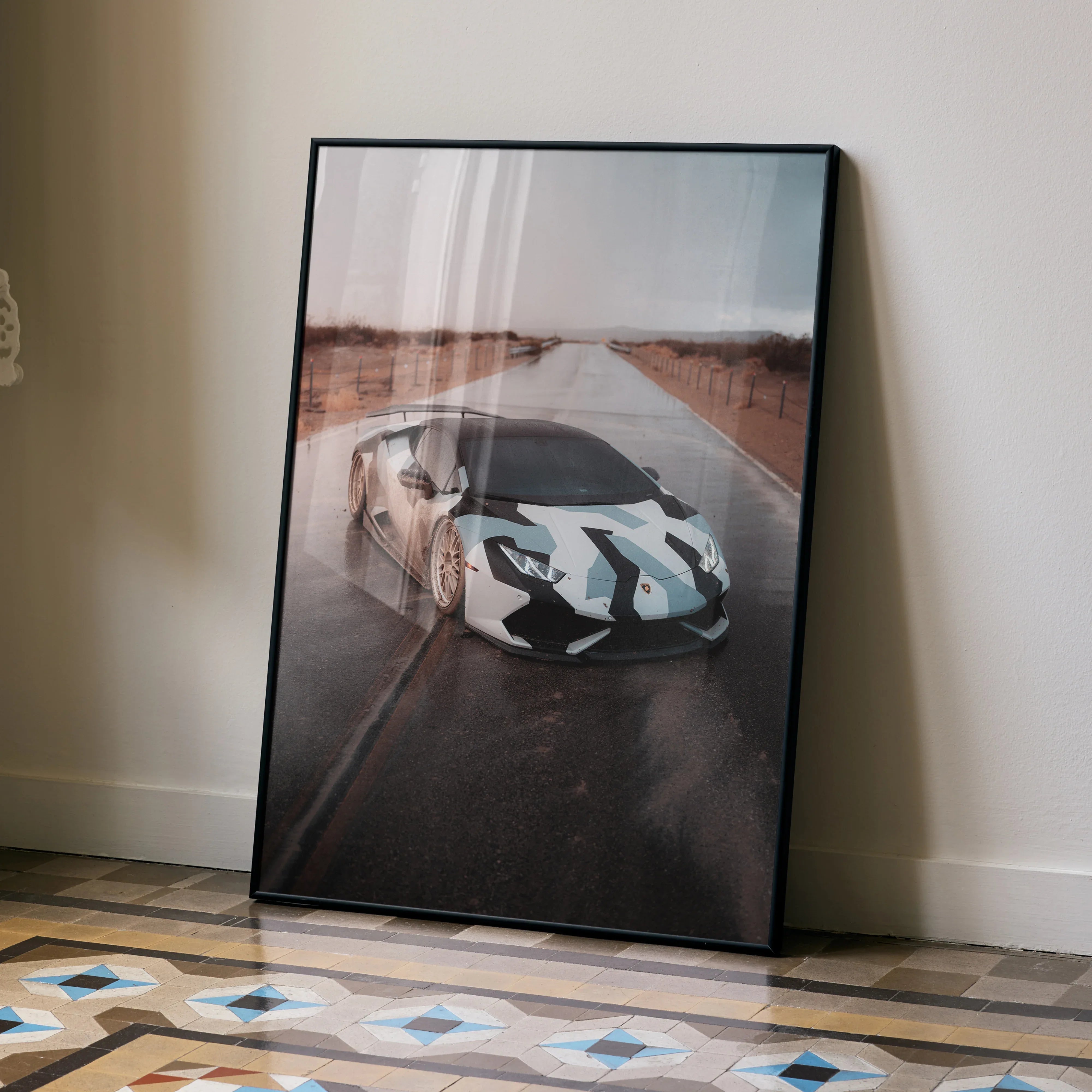 Lamborghini Huracan poster featuring a white sports car with blue racing stripes on a desert road, modern wall art.