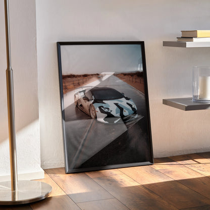 Lamborghini Huracan wall art poster in black frame leaning against wall on wooden floor.