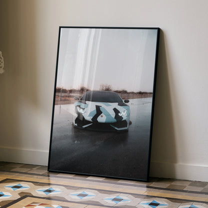 Lamborghini Huracan poster with camo design reflected on wet pavement, modern wall art in black frame.