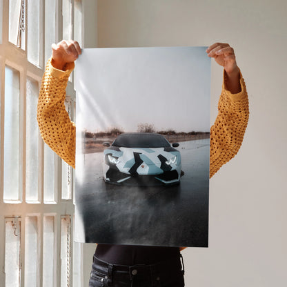 Lamborghini Huracan poster wall art with sleek black and white camo sports car on reflective surface.
