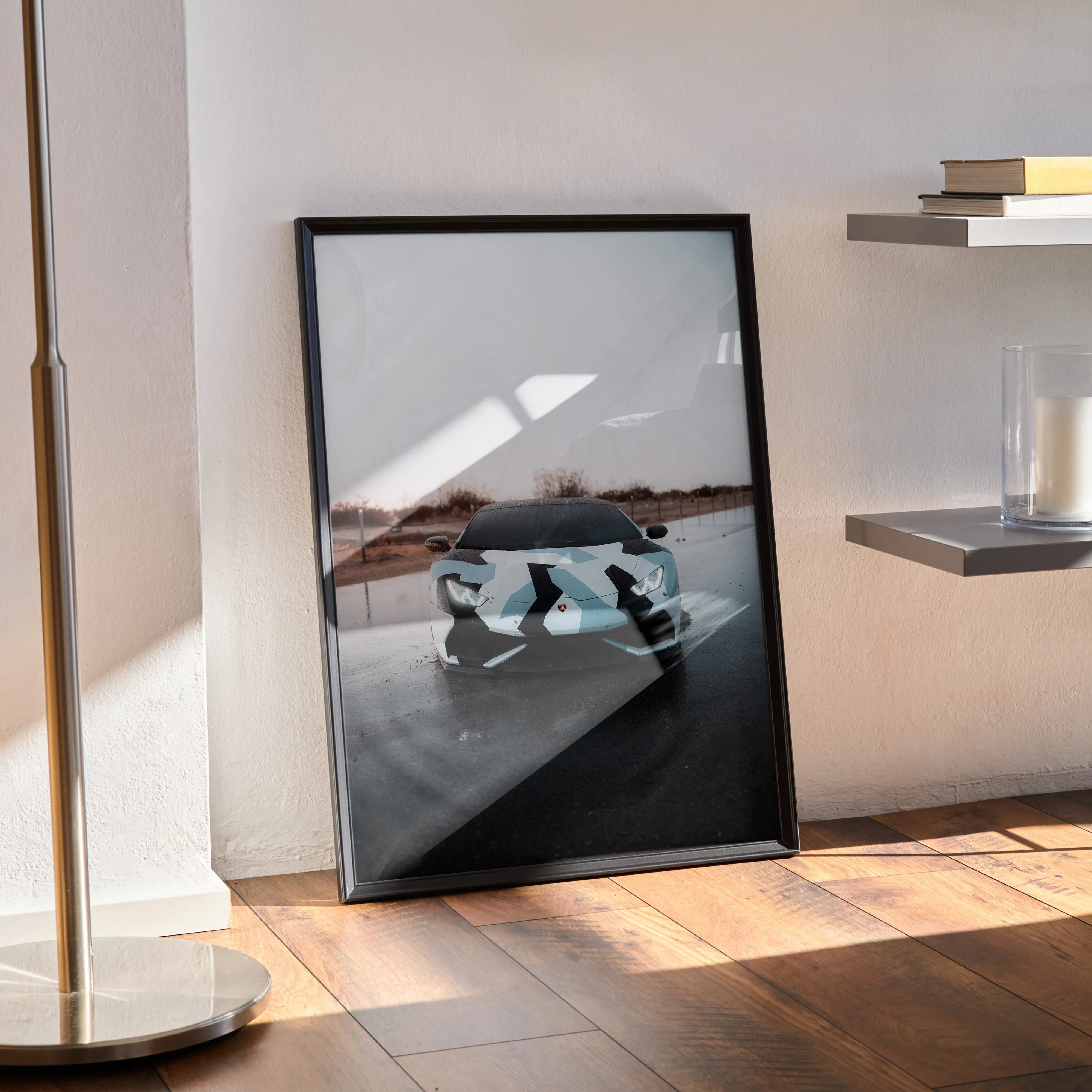 Lamborghini Huracan poster wall art in black frame leaning against white wall on wooden floor.
