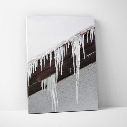 Canvas wall art featuring detailed digital art of long icicles hanging from a dark wooden roof edge against a snowy white.