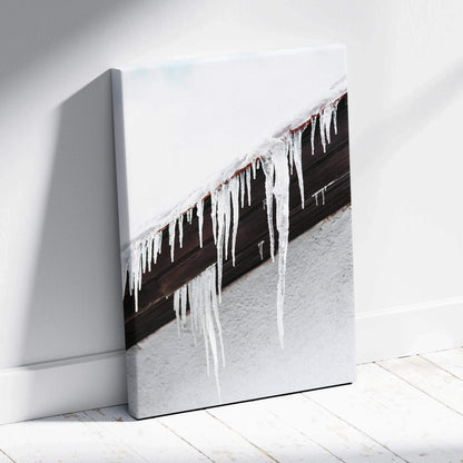 Canvas wall art featuring close-up of roof icicles with snow on textured white wall background.
