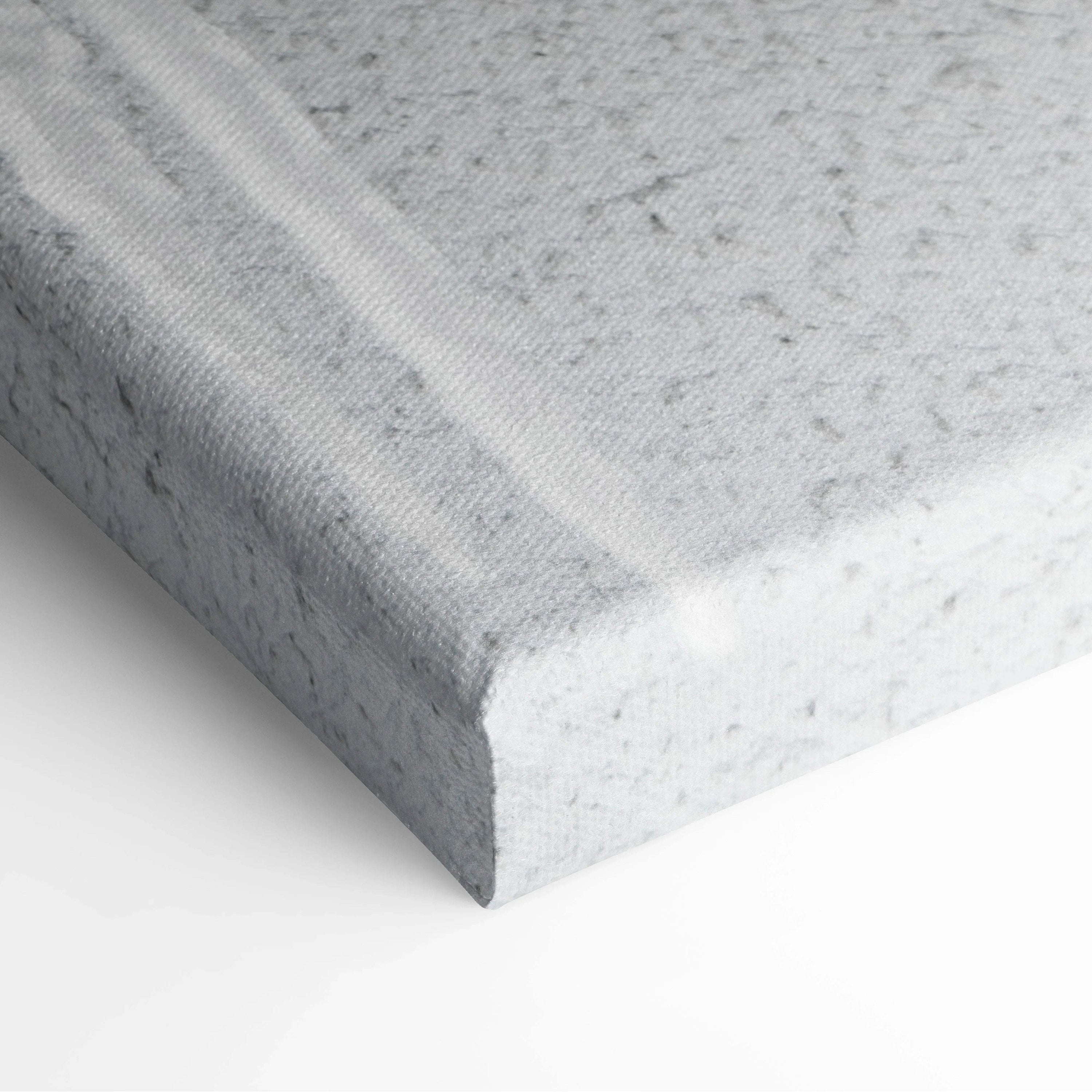 Close-up of textured canvas edge with winter snowfall scene printed in muted gray and white tones for wall art decor.