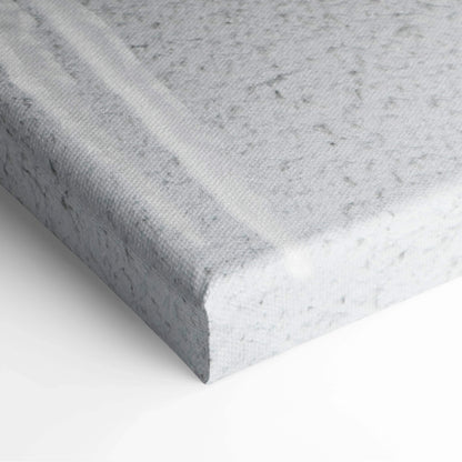 Close-up of textured canvas edge with winter snowfall scene printed in muted gray and white tones for wall art decor.