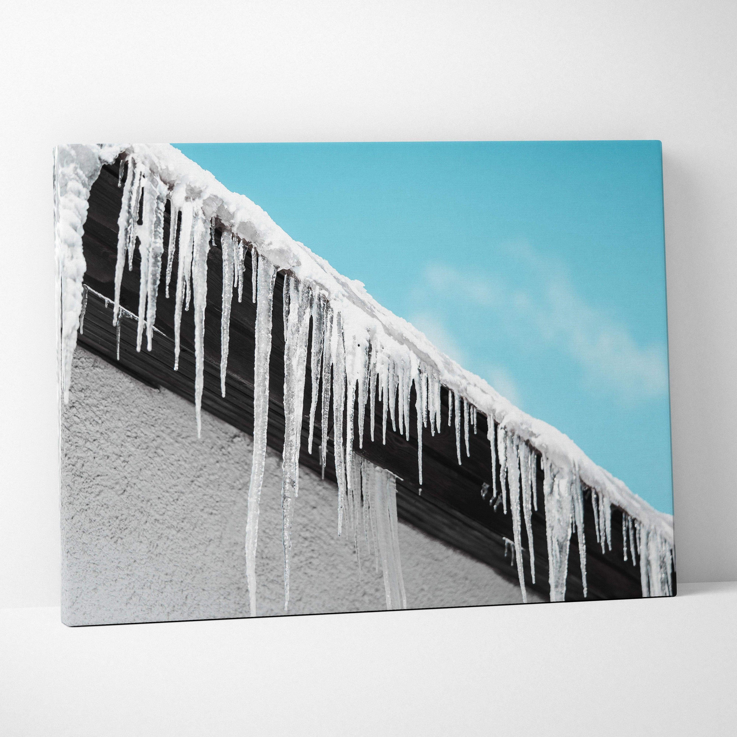 Canvas wall art featuring long, clear icicles hanging from a snow-covered roof against a bright blue sky.