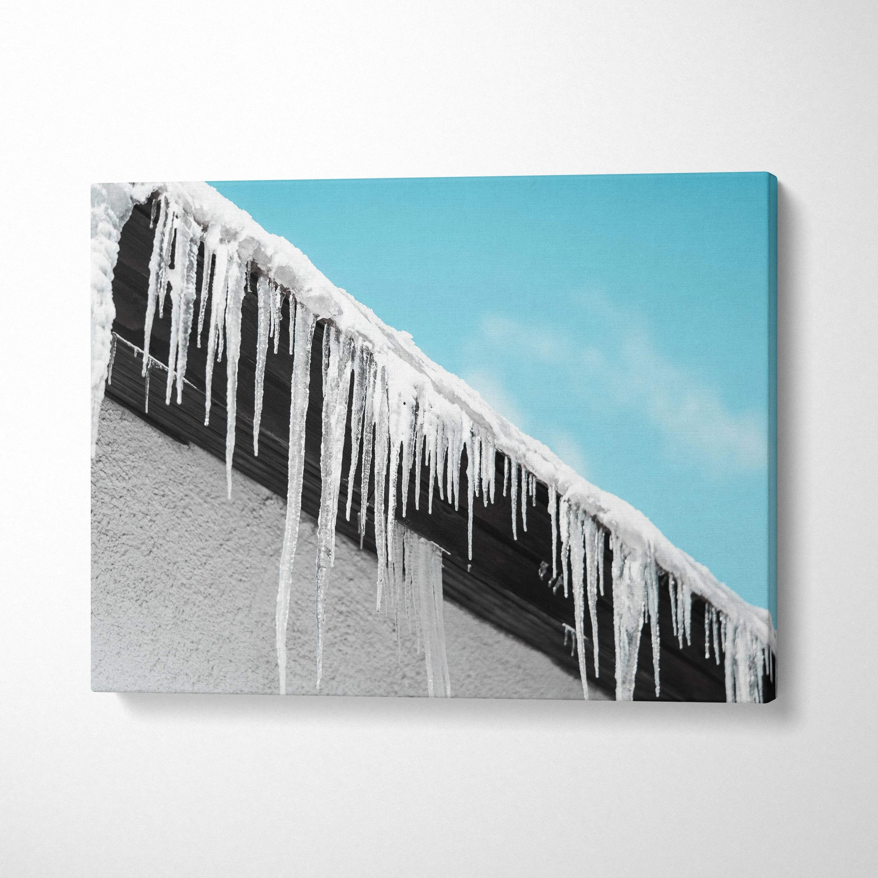 Canvas wall art featuring stunning winter roof icicles with bright blue sky and snowfall decor.