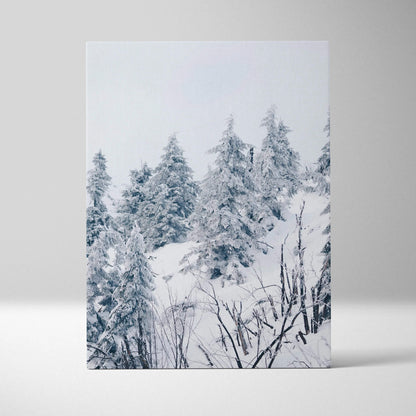 Winter landscape canvas wall art featuring snow-covered trees in a serene forest decor piece.