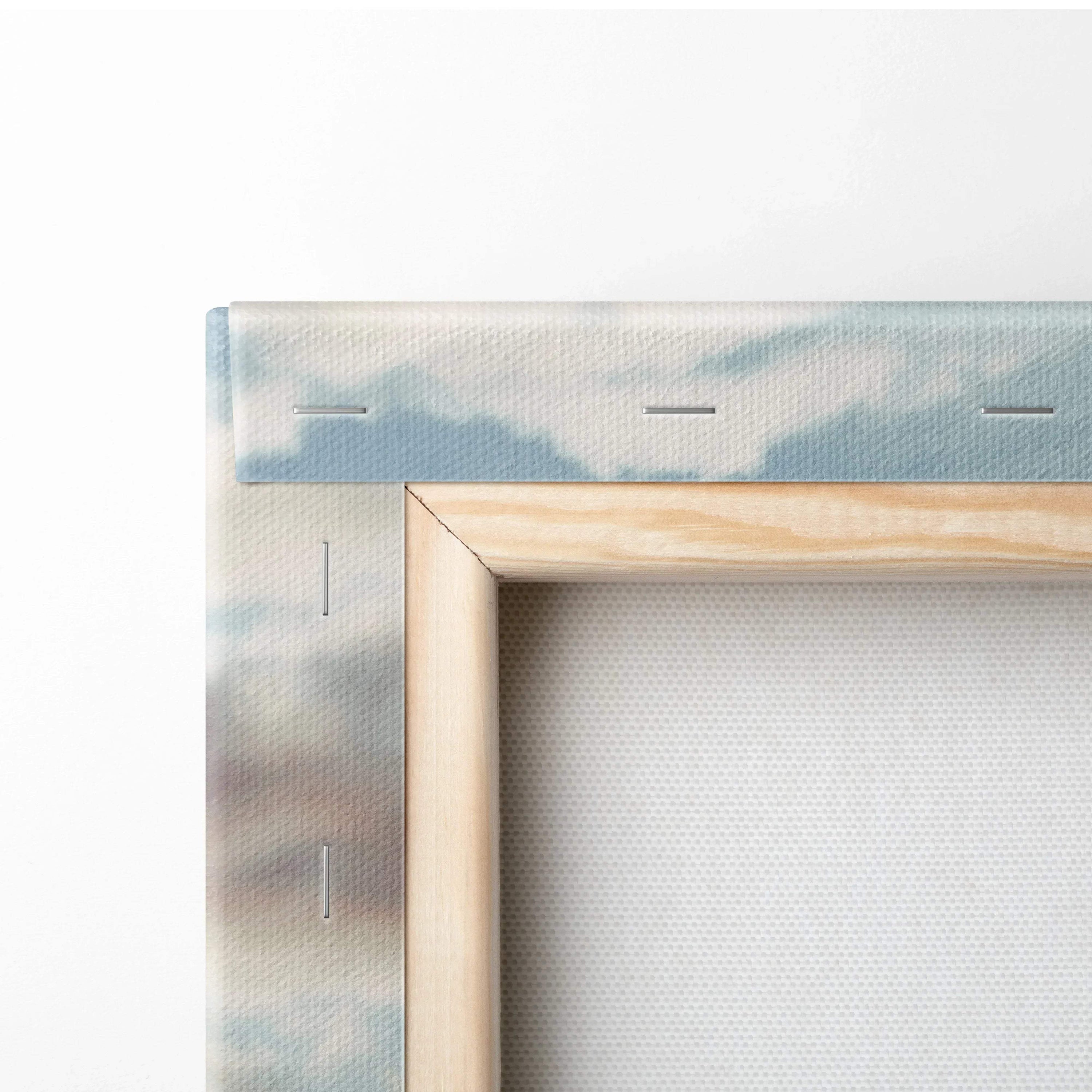 Close-up of wooden frame and stapled edges on stretched canvas wall art with soft blue and beige tones on fabric.