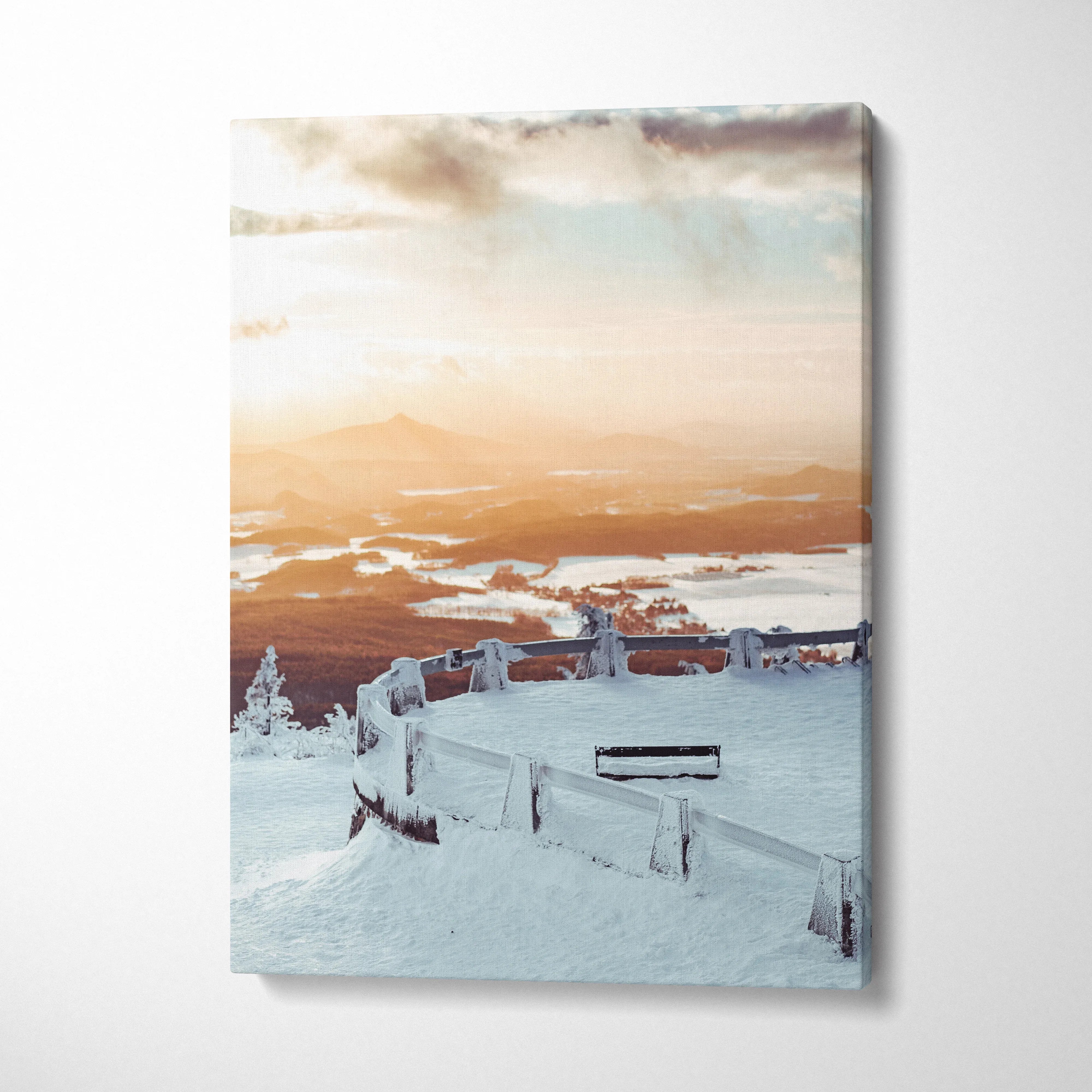 Vertical canvas wall art featuring a snowy winter landscape at sunset with soft orange and blue tones decor.