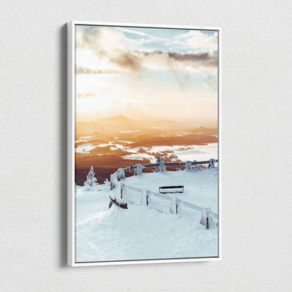 Canvas wall art featuring a snowy landscape at sunset with soft orange and blue hues.
