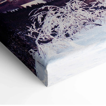 Canvas wall art featuring a snowy winter scene with delicate white branches against a dark purple and orange sunset sky.