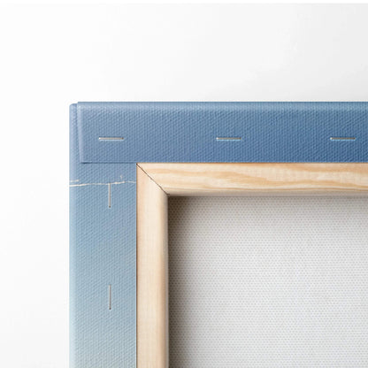 Close-up of corner of blue gradient stretched canvas with wooden frame and visible staples.