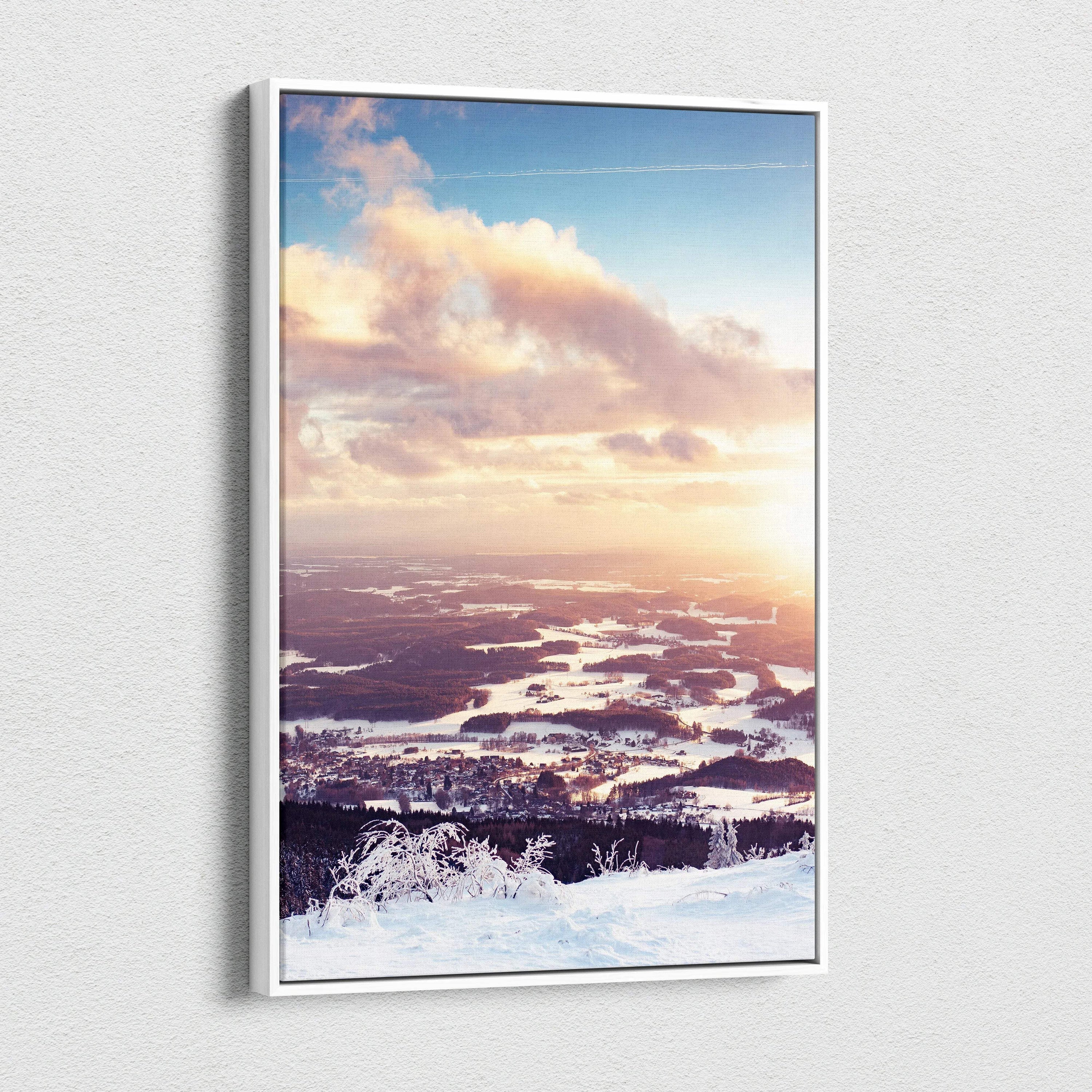 Canvas wall art displaying a snowy winter landscape at sunset with soft pink and orange clouds over a frozen terrain.
