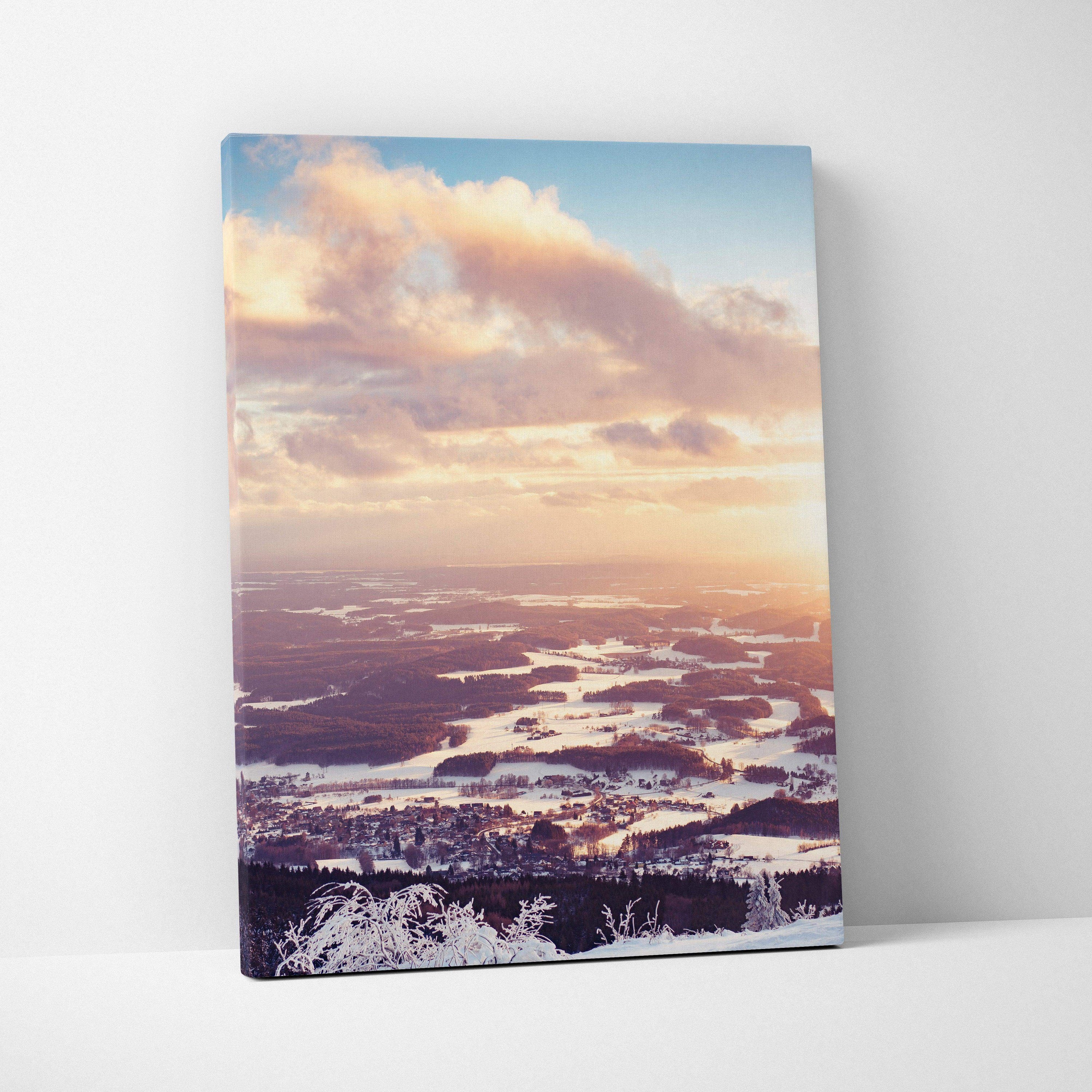 Canvas wall art featuring a snowy winter landscape at sunset with soft pastel sky tones and winding rivers.