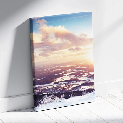 Canvas wall art featuring a snowy winter landscape with a colorful sunset sky in soft pinks and blues.
