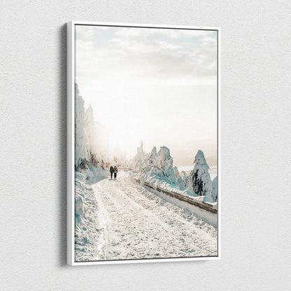 Canvas wall art depicting a snowy road winding through frost-covered trees under a soft, cloudy sky.