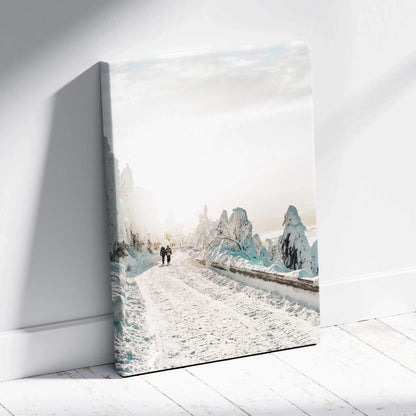 Canvas wall art featuring a serene snowy road flanked by snow-covered trees in soft winter tones.