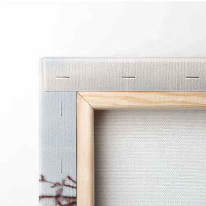 Close-up of stretched canvas wall art corner with white fabric and light wood frame.