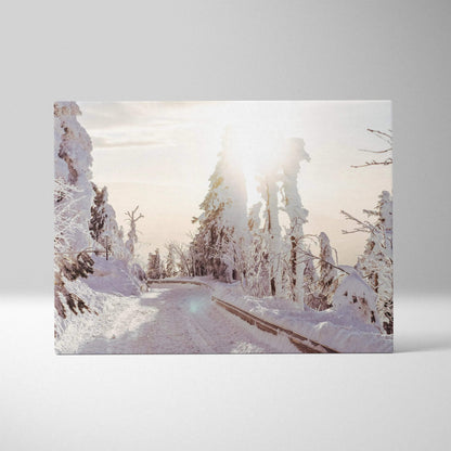 Winter landscape canvas wall art with snowy trees and soft sunlight glow.