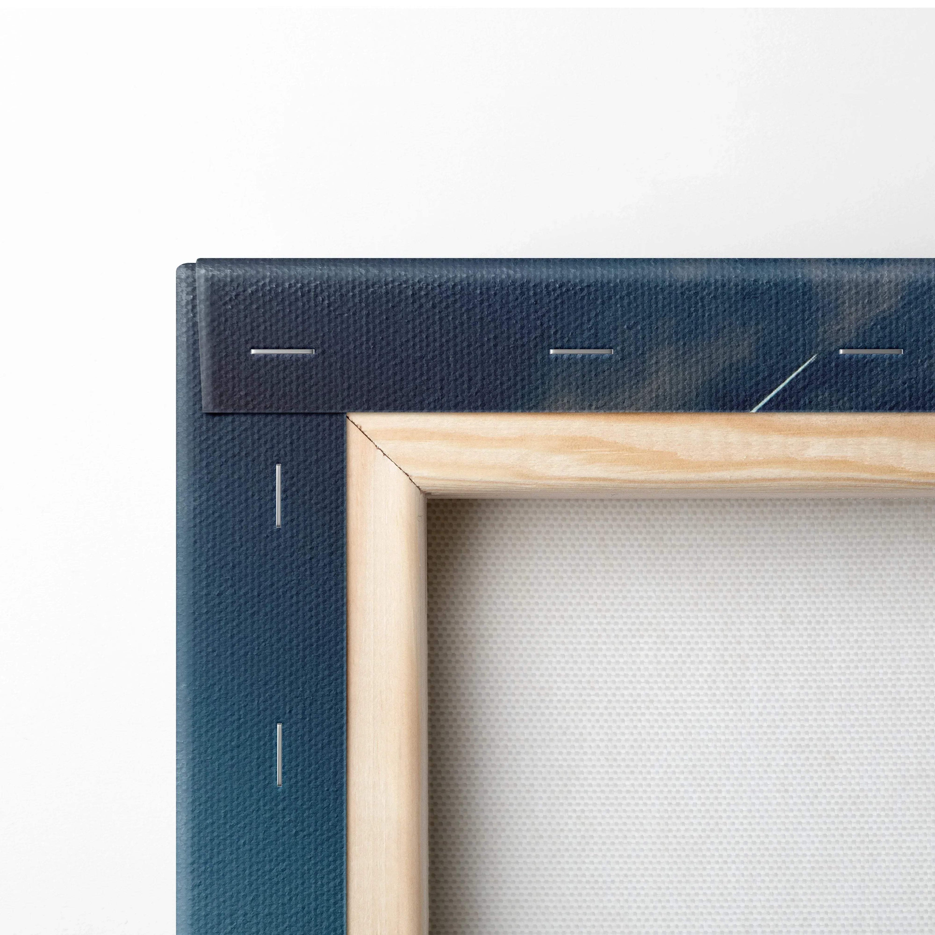 Close-up of stretched wooden frame with dark blue canvas edge and visible staples for wall art decor.