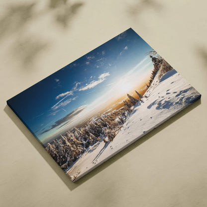 Digital canvas wall art featuring a snowy winter landscape with frosted trees under a blue sky at sunset.