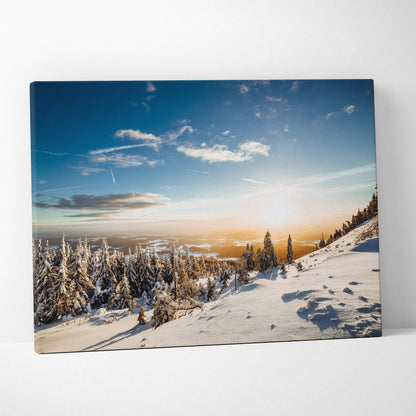 Digital canvas wall art of snowy winter trees under a blue sky with soft sunlight on a snowy hillside.