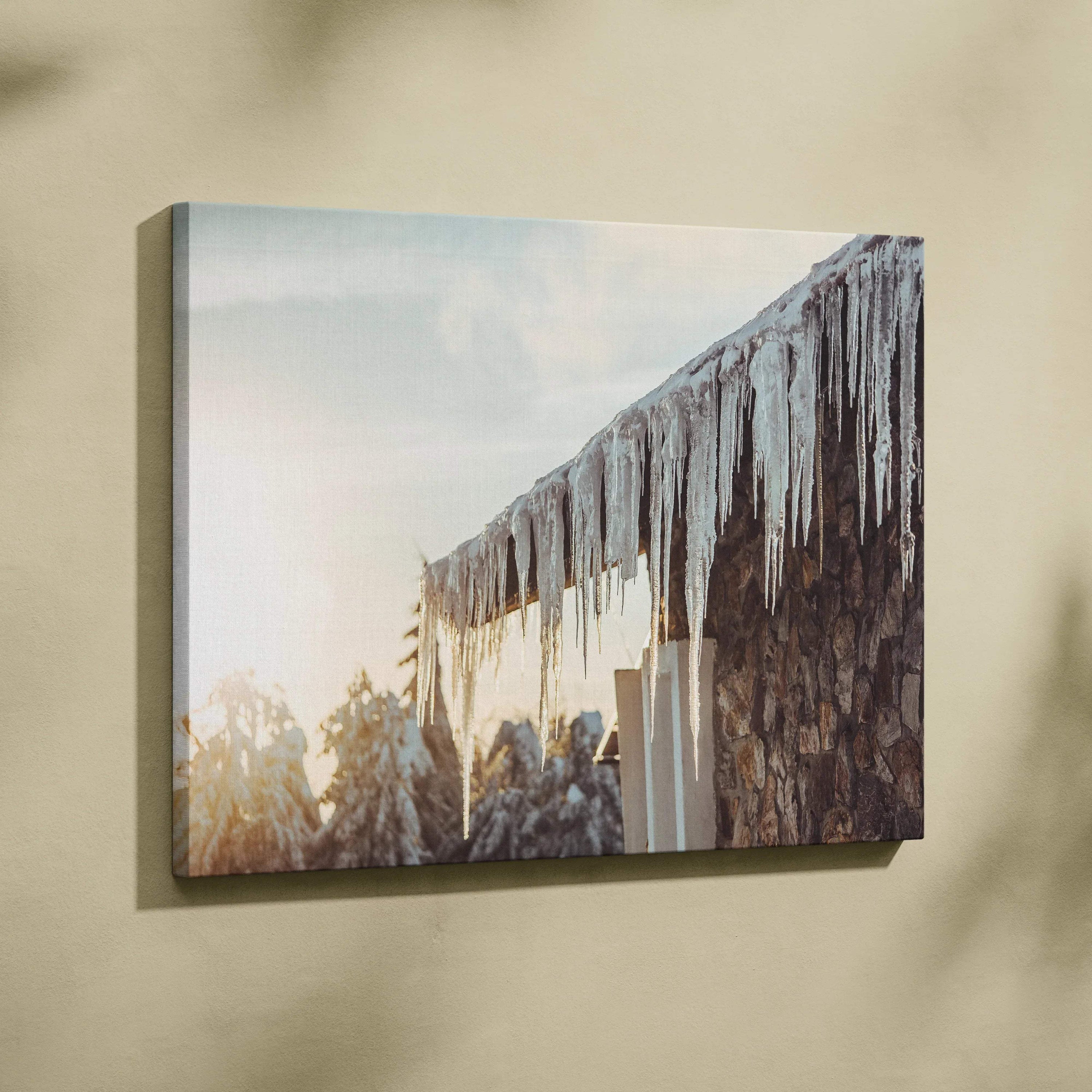 Winter canvas wall art featuring glistening icicles hanging from a roof with soft sunlight decor.