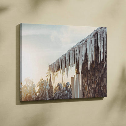 Winter canvas wall art featuring glistening icicles hanging from a roof with soft sunlight decor.