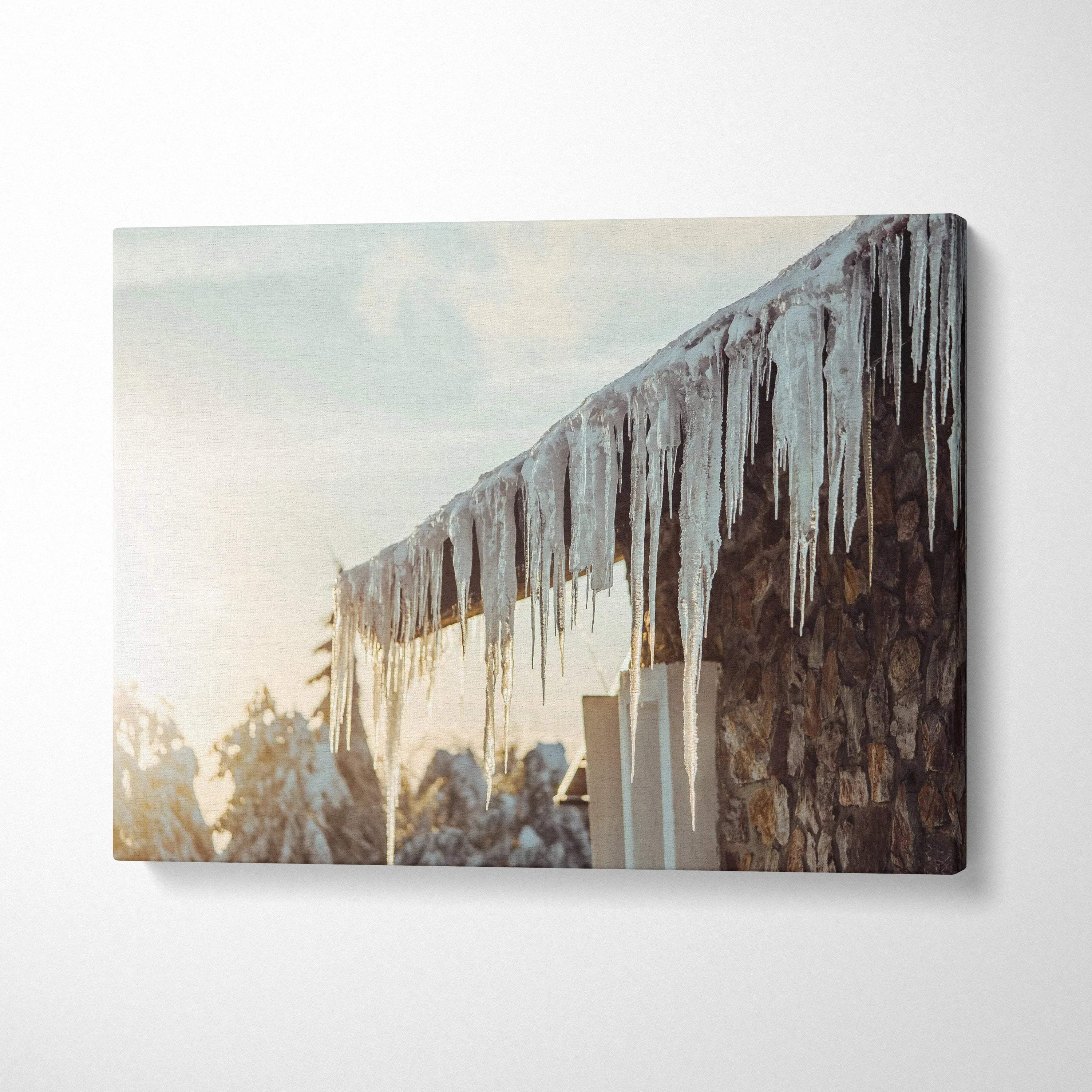 Canvas wall art featuring winter scene with glistening icicles hanging from a rustic roof edge.