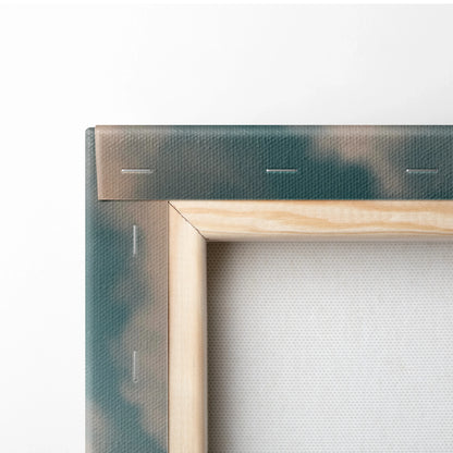 Close-up of wooden framed canvas with muted blue and gray tones showing staples and fabric texture.