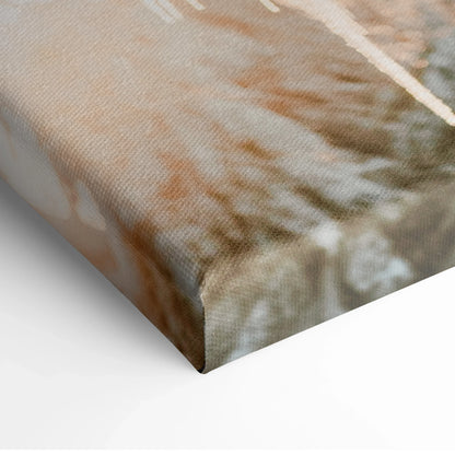 Close-up of canvas wall art corner showing textured fabric and part of a snowy winter landscape with soft brown and white.