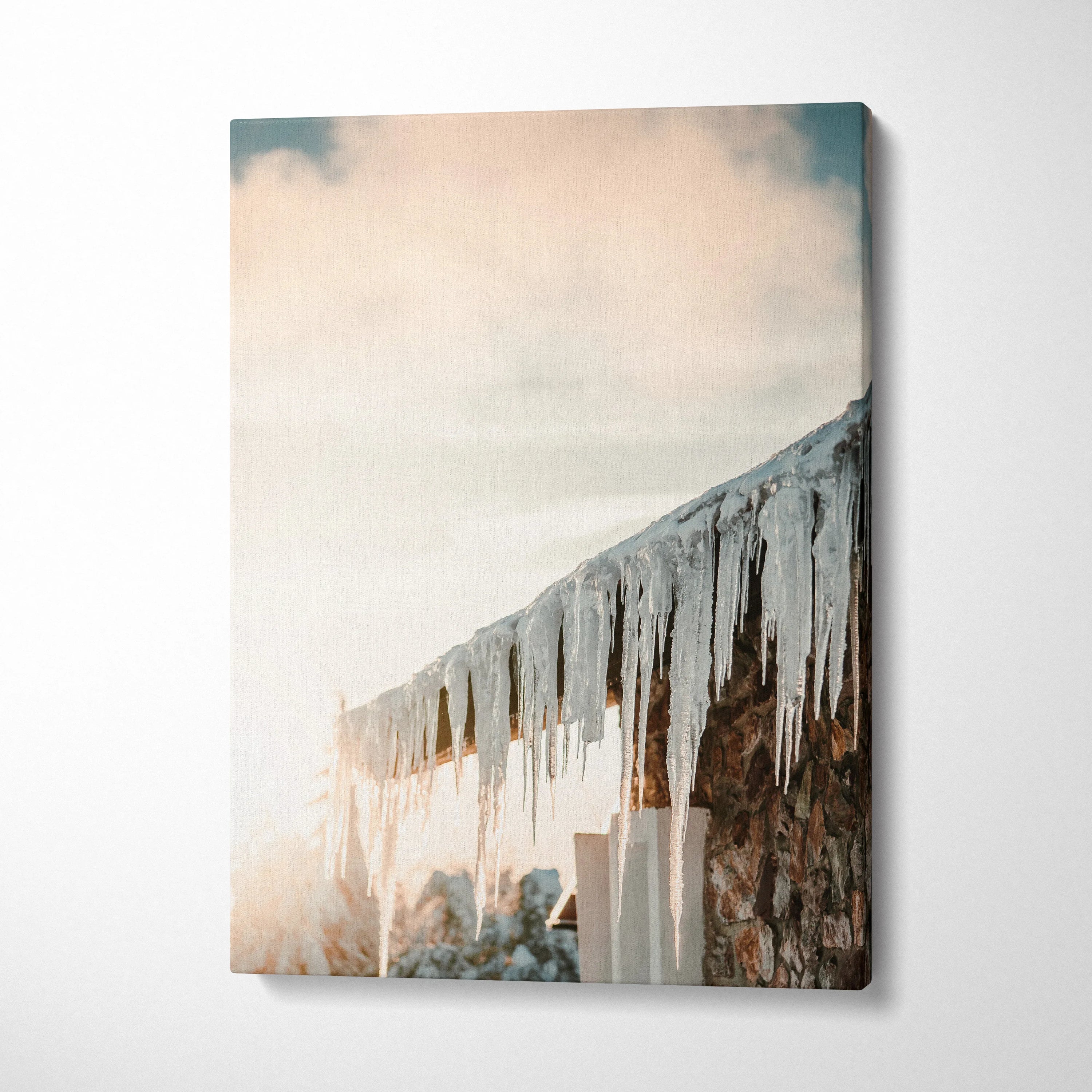 Winter-themed canvas wall art featuring glistening roof icicles with soft snowy landscape background, vertical decor.