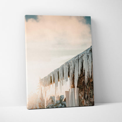 Canvas wall art featuring glistening icicles hanging from a snowy roof against a soft sky background.