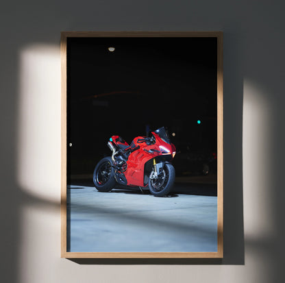 Ducati Panigale V4S red sport motorcycle poster framed as wall art in soft lighting.