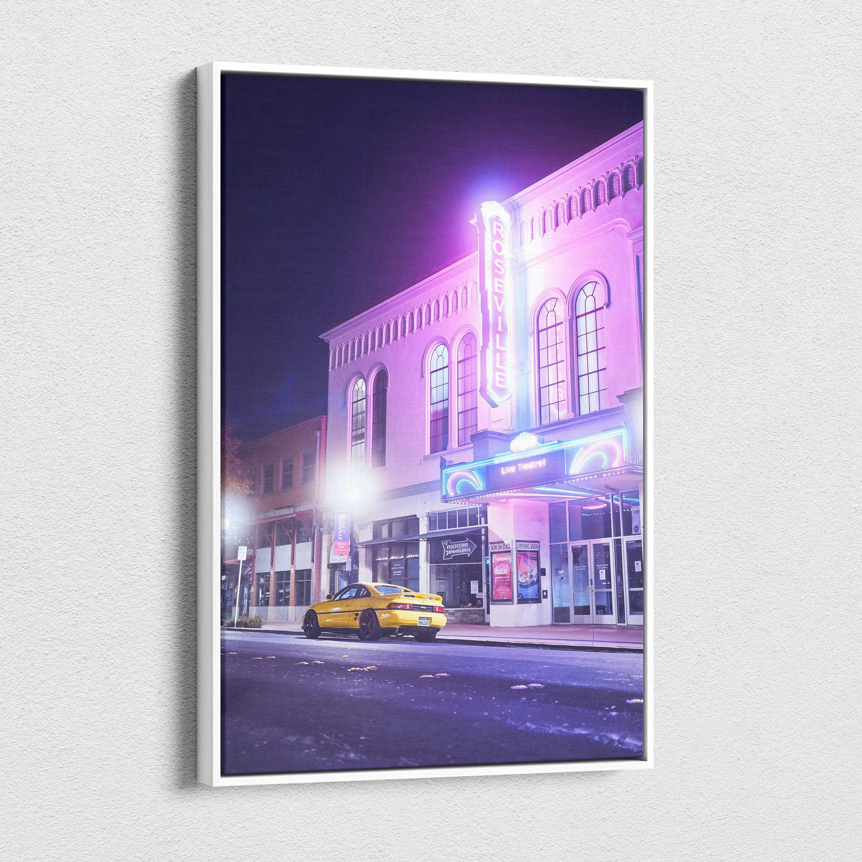 Toyota MR2 canvas wall art featuring a glowing neon theater and yellow sports car at night.