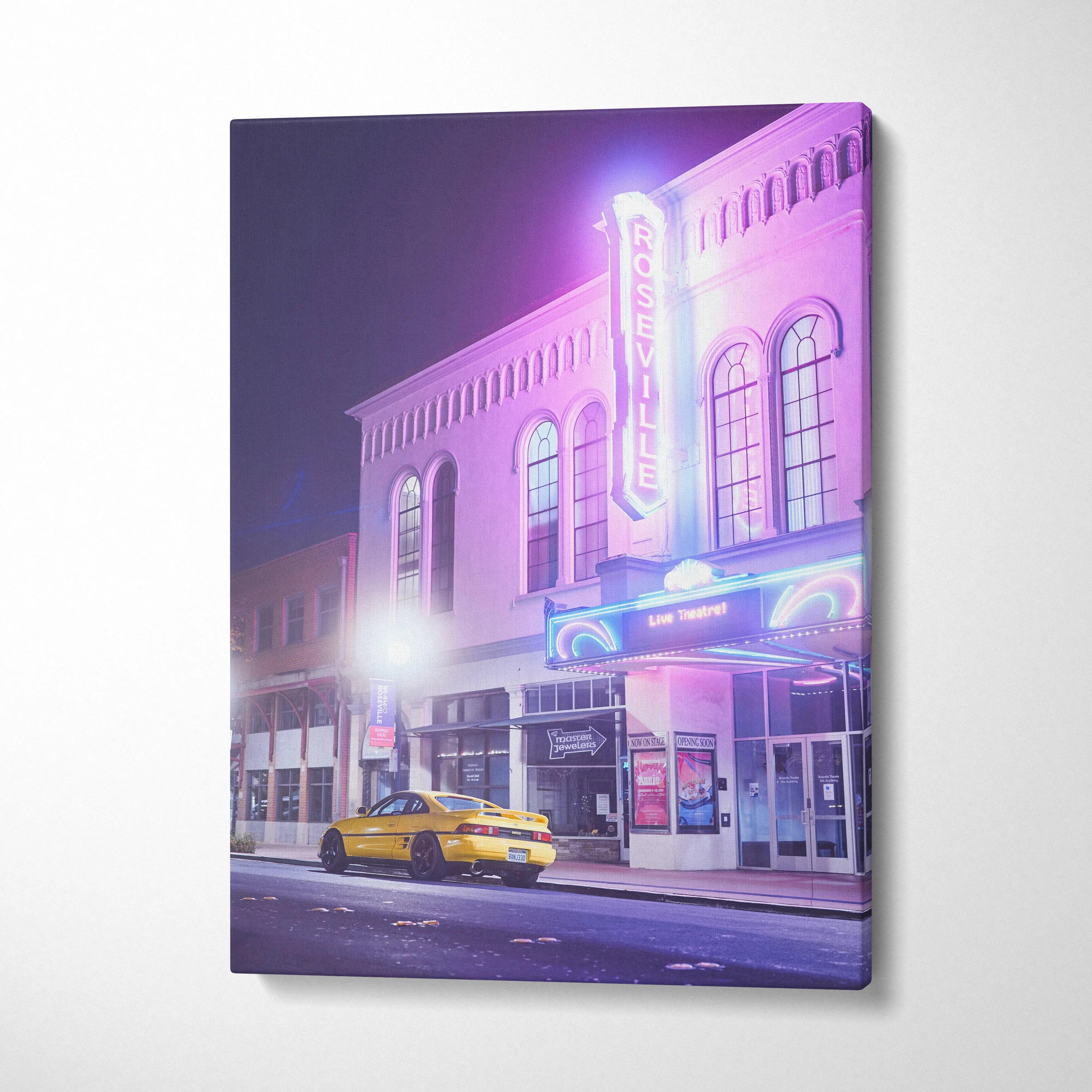 Toyota MR2 sports car parked outside neon-lit theater canvas wall art in vertical orientation.