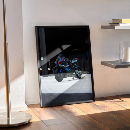 BMW M1000RR motorcycle poster with black frame leaning against wall, modern room wall art.