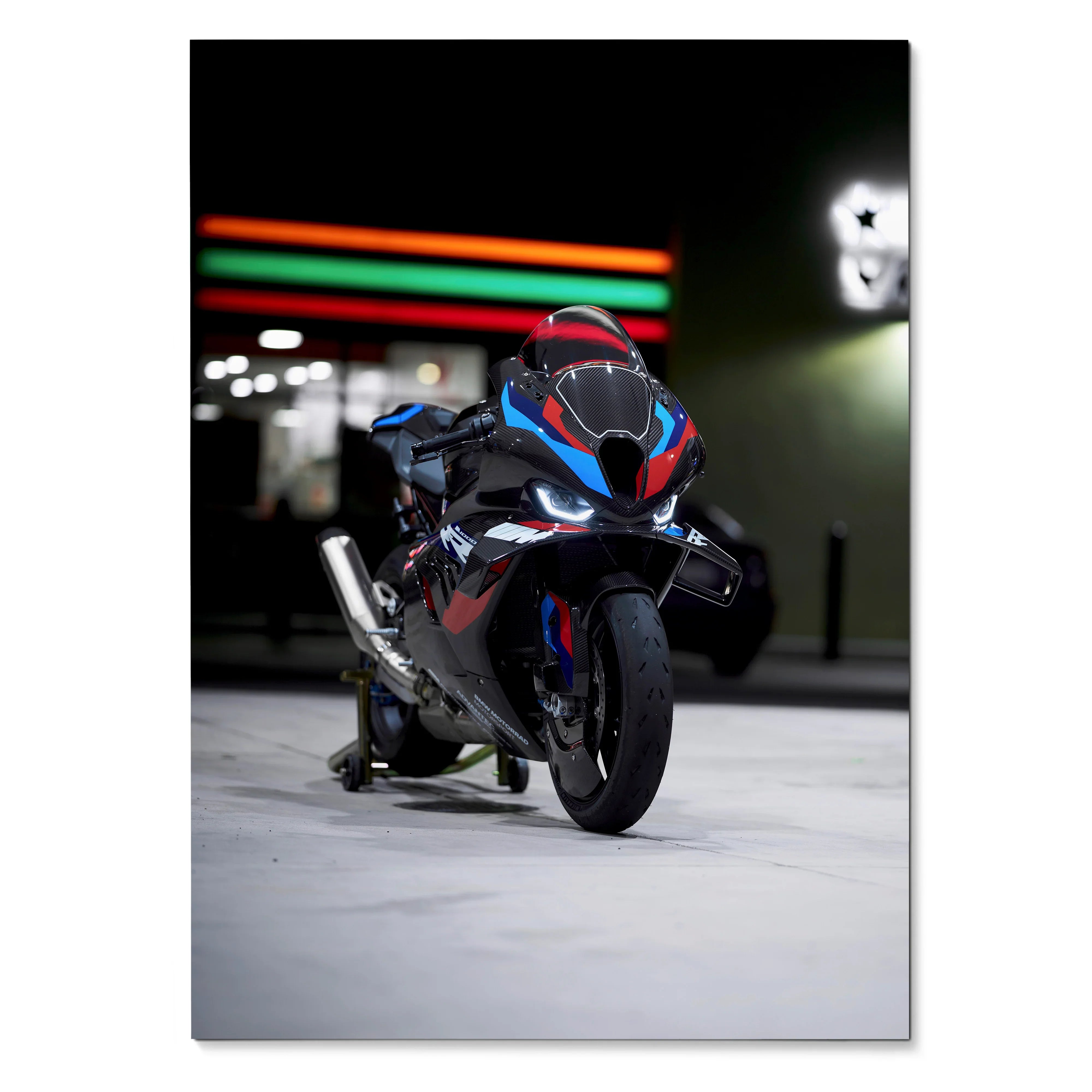 BMW M1000RR motorcycle at night with vibrant red and blue accents poster wall art.
