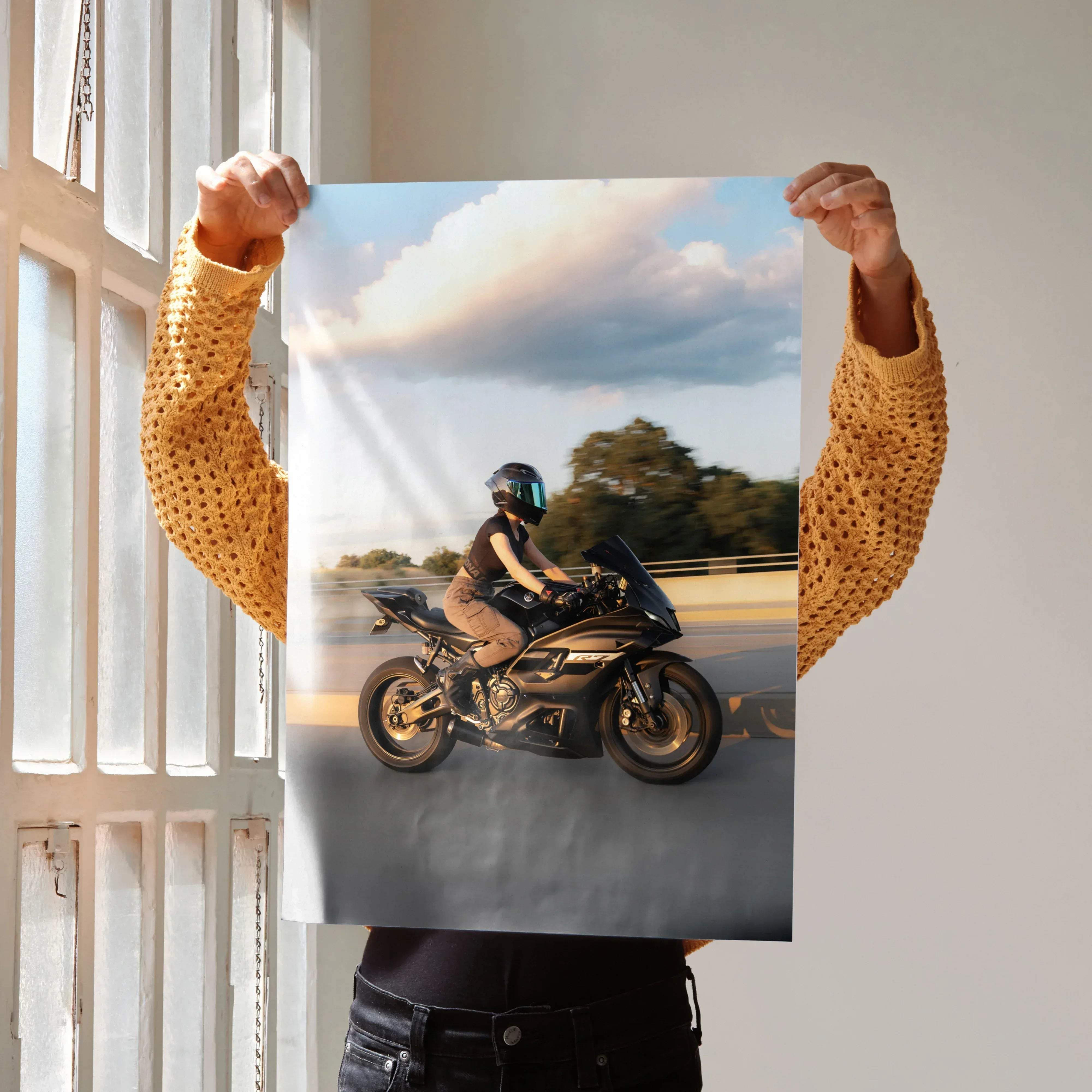 A black and gold sport motorcycle with a rider wearing an AGV Pista helmet on a rectangular biker poster