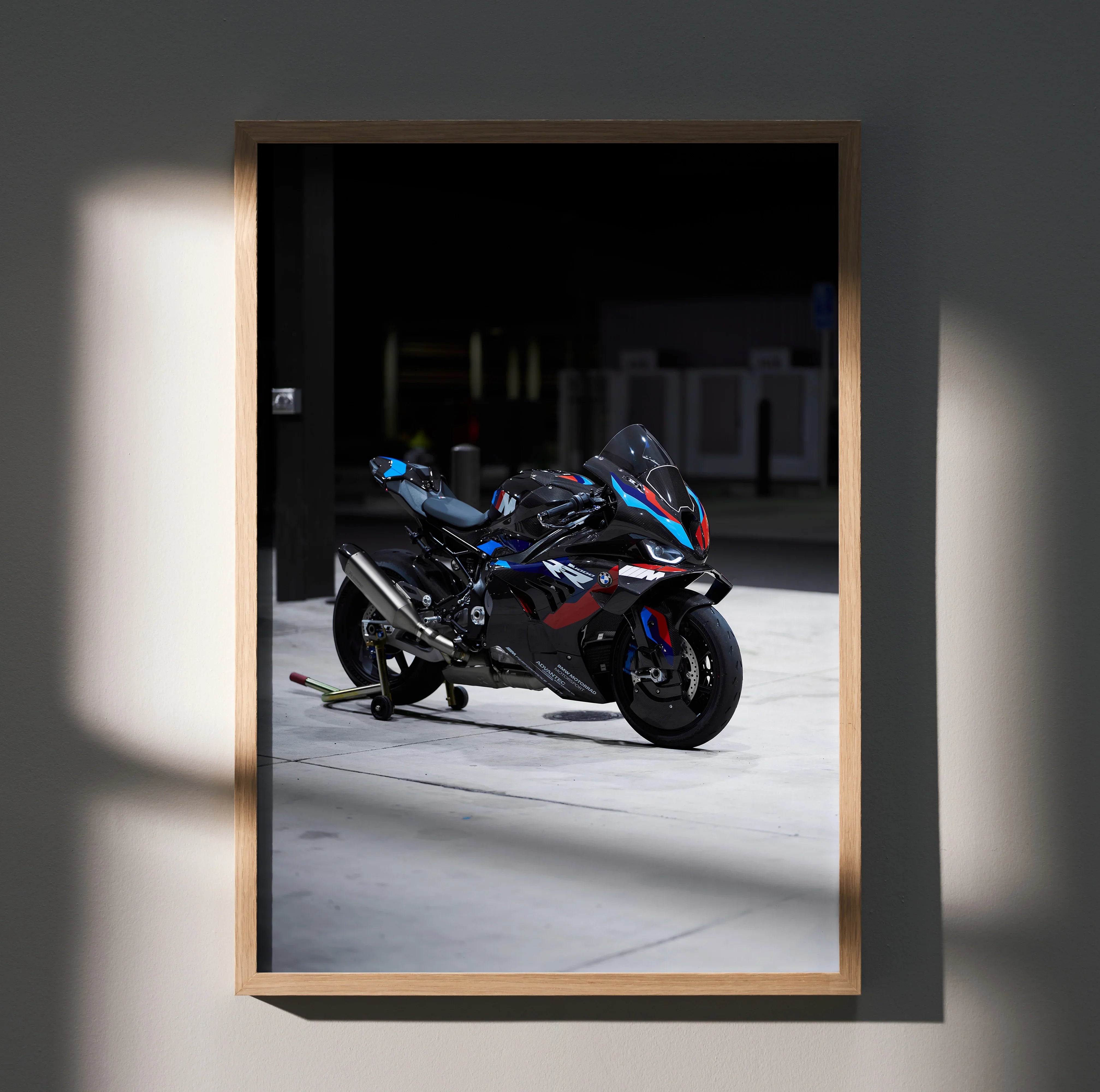 BMW M1000RR motorcycle poster wall art with sleek black and blue racing design in wooden frame.