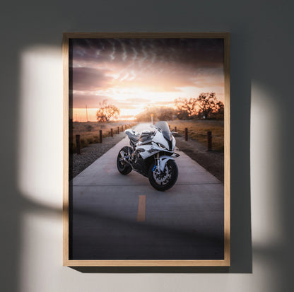 BMW S1000RR motorcycle poster with sunset background, sleek white bike wall art in wooden frame.