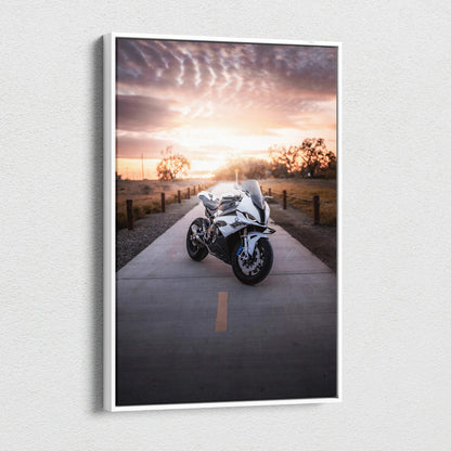 Vertical canvas wall art featuring a BMW S1000RR motorcycle on a sunset road with dramatic sky.