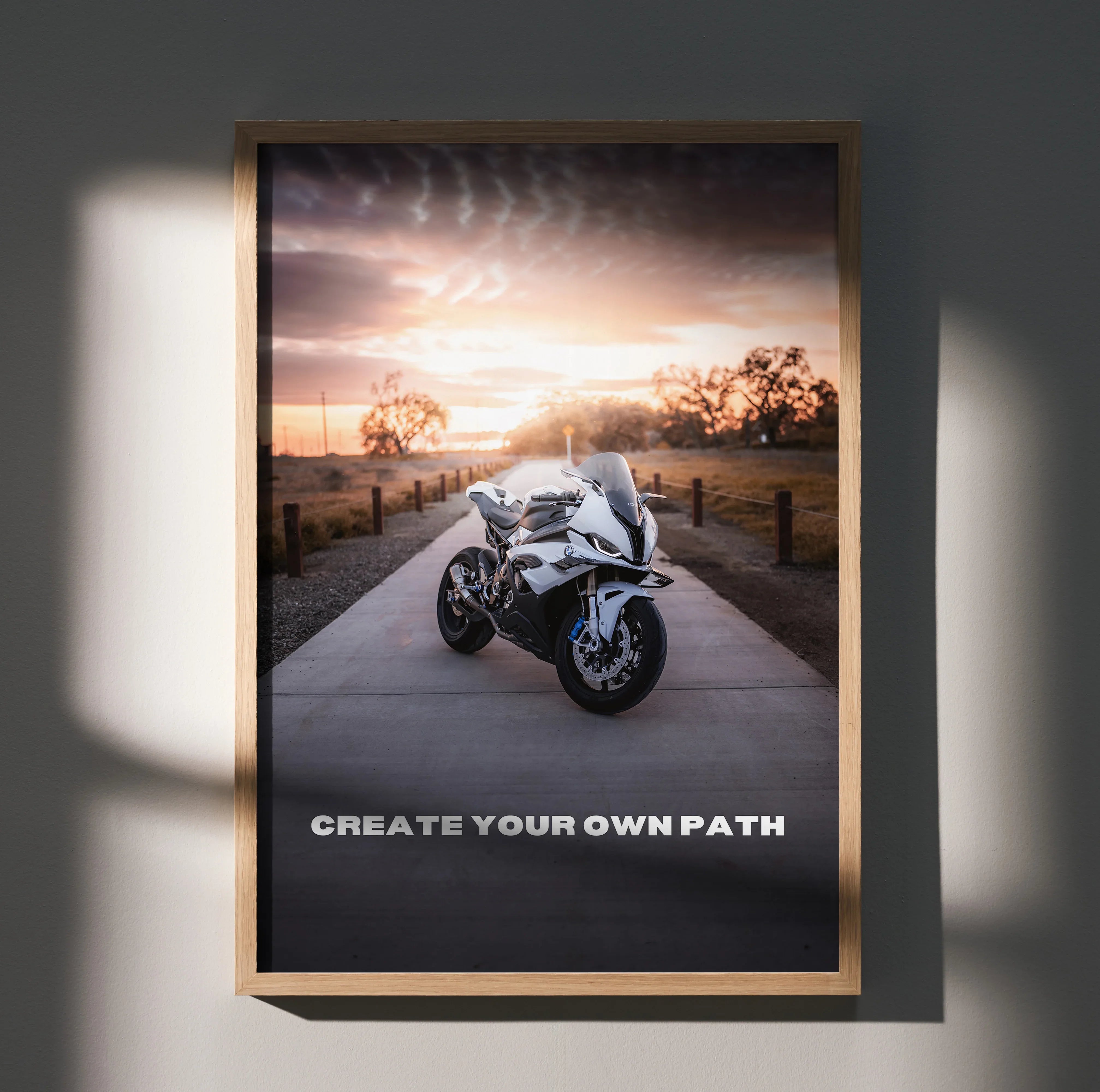Motivational wall art poster featuring BMW S1000RR motorcycle on road at sunset with "Create Your Own Path" text.
