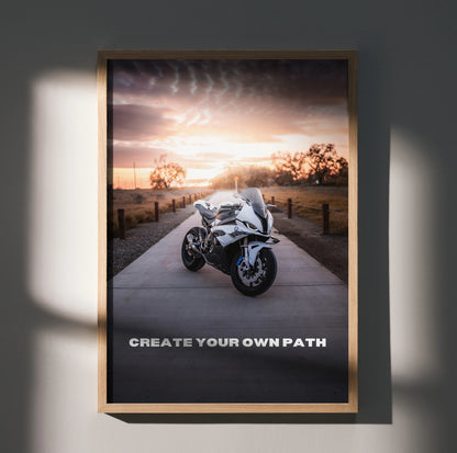 Motivational wall art poster featuring BMW S1000RR motorcycle on road at sunset with "Create Your Own Path" text.