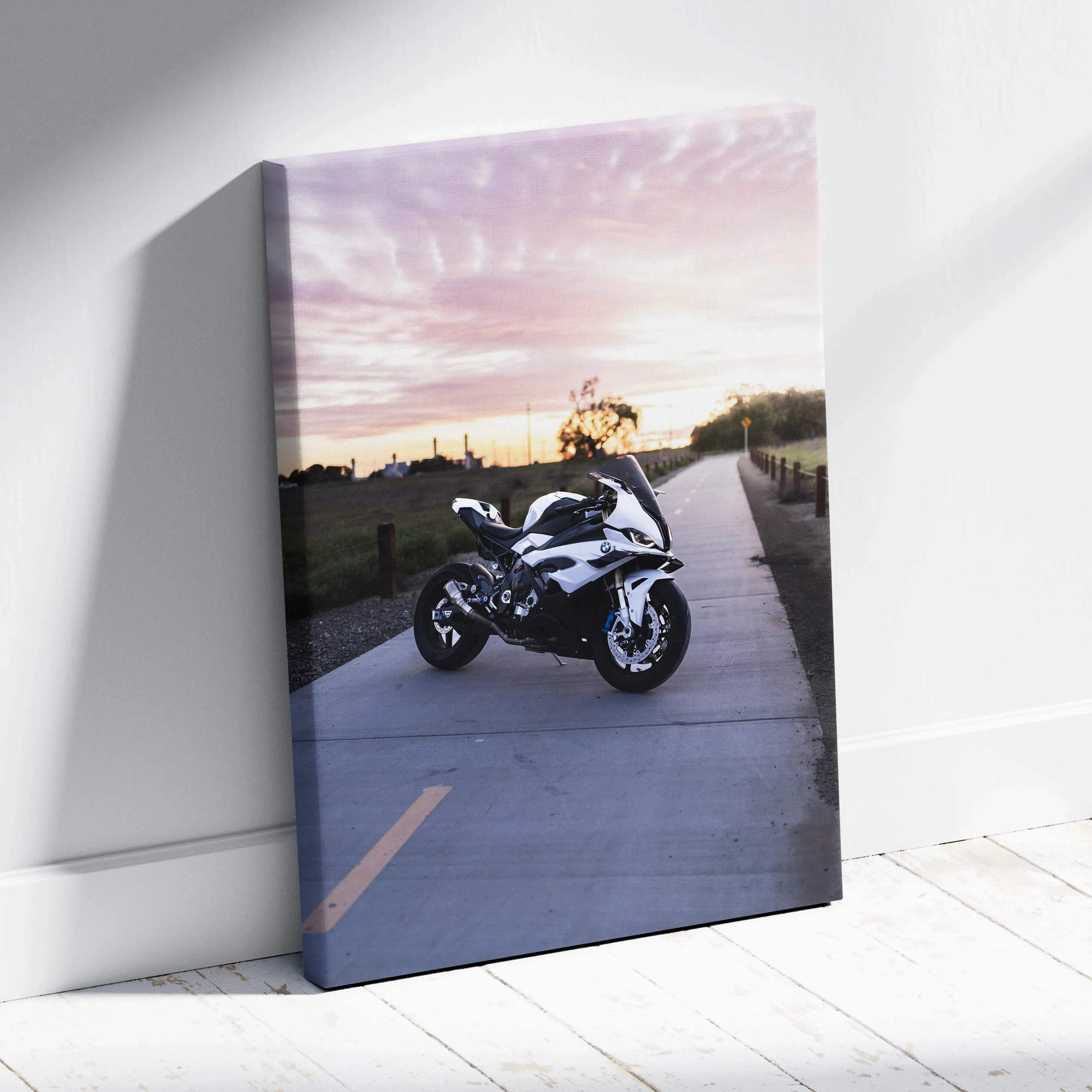 BMW S1000RR motorcycle parked on sunset path canvas wall art with soft pink sky.