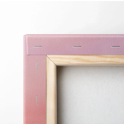 Close-up of wooden frame corner with pink canvas wrap and tight staples for wall art canvas print.