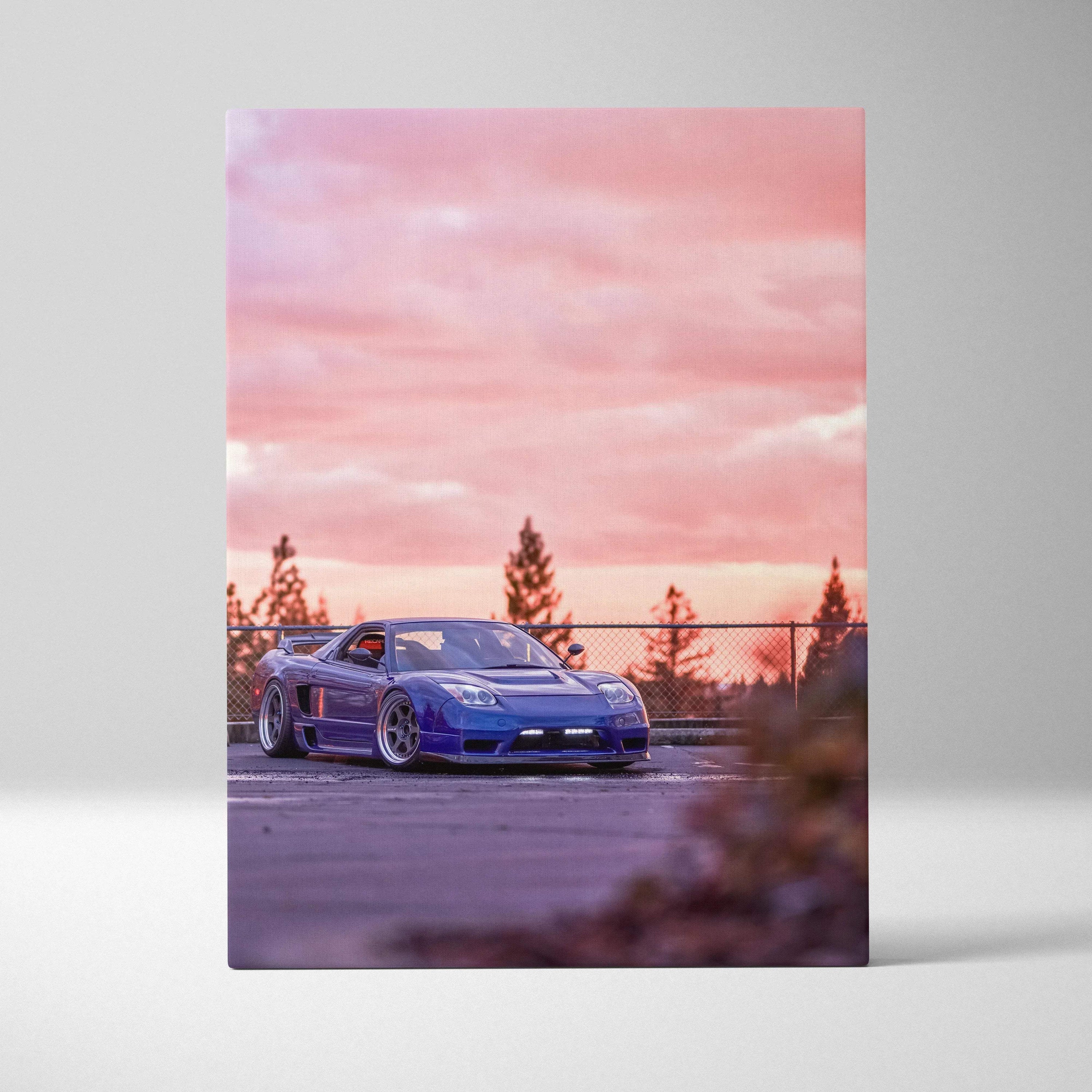 Vertical canvas art of a blue Acura NSX parked with pink sunset sky and trees in background.