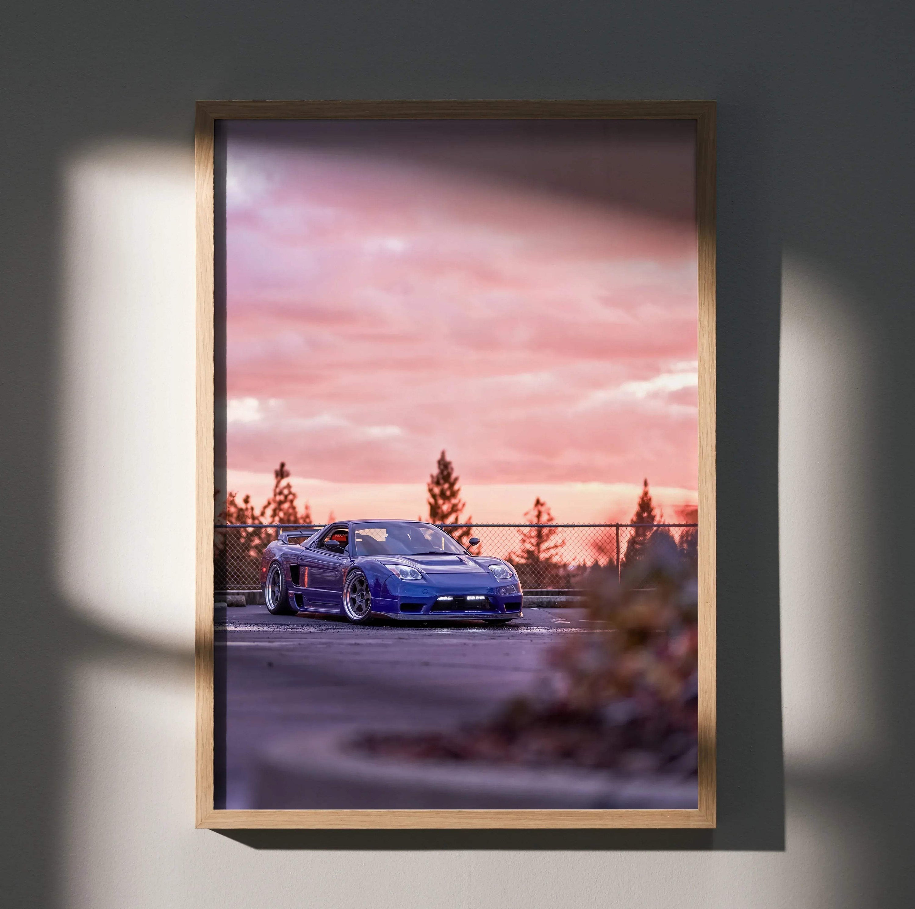 Acura NSX sports car at sunset with pink sky poster wall art in wooden frame.