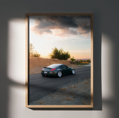 Nissan 350z car driving on road at sunset poster wall art in wooden frame.